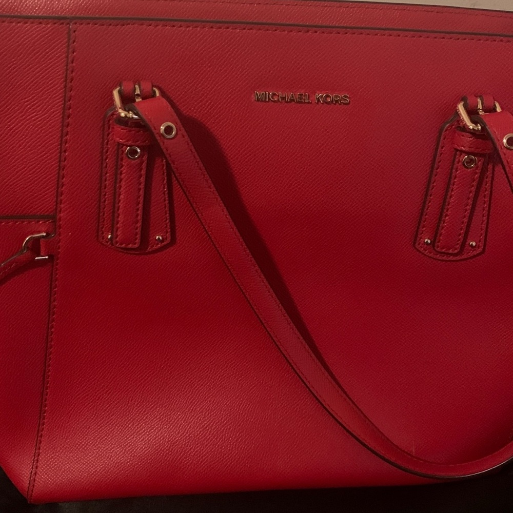 Red with gold outline MK handbag.